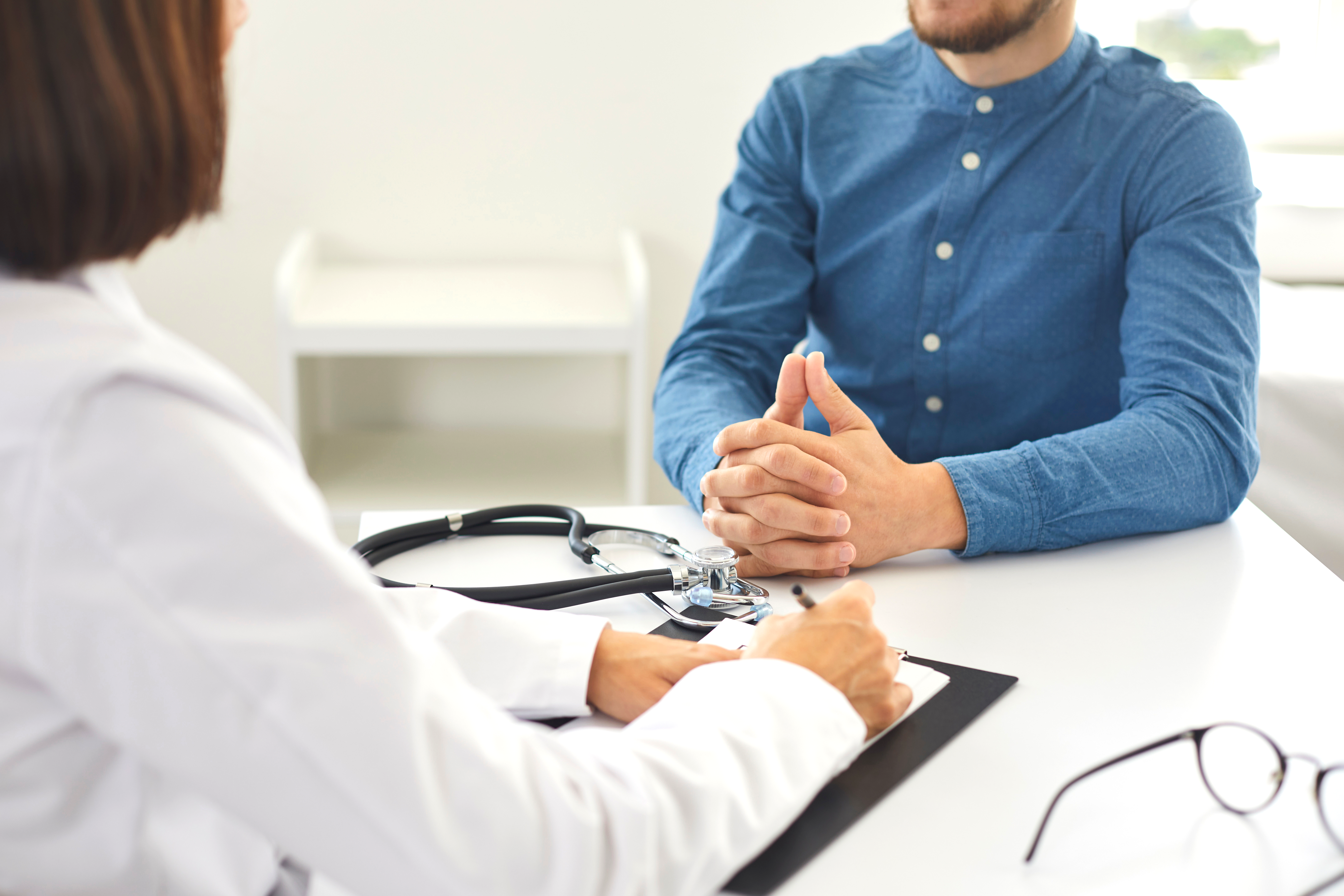 man sitting and having conversation with doctor